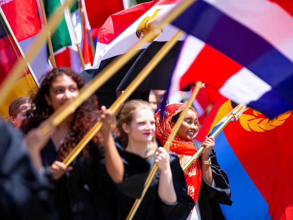 International student with country flag in procession