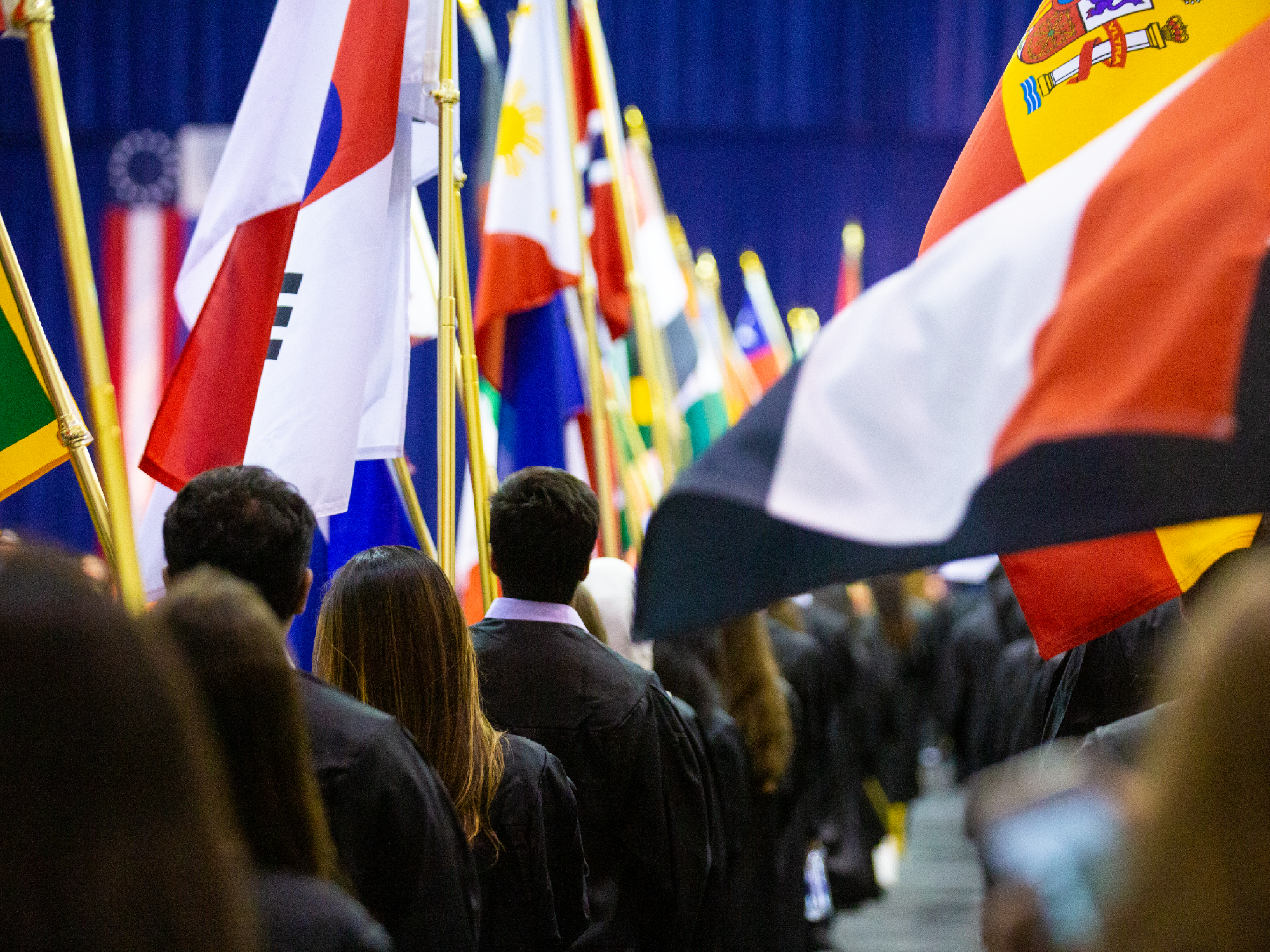 Image of students carrying flags from all over the world