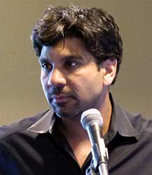 Jishnu Das giving a speech with a microphone in front of him.