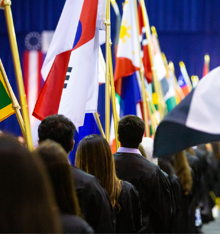 Image of students carrying flags from various countries