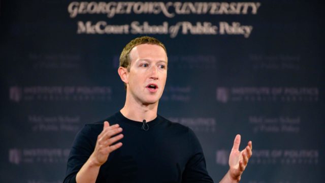 Mark Zuckerberg at podium giving a talk in Gaston Hall