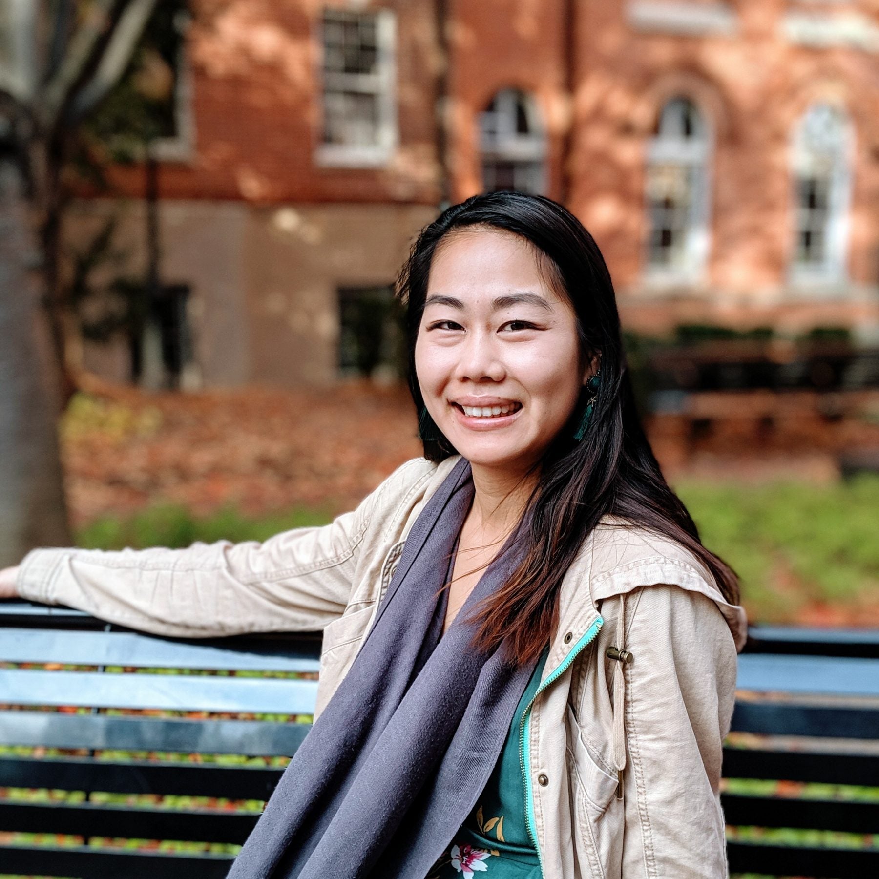 Frances Chen smiling sitting on a bench at Georgetown