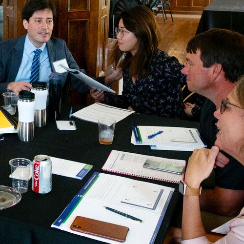 CEF Students sitting around a table during a class discussion