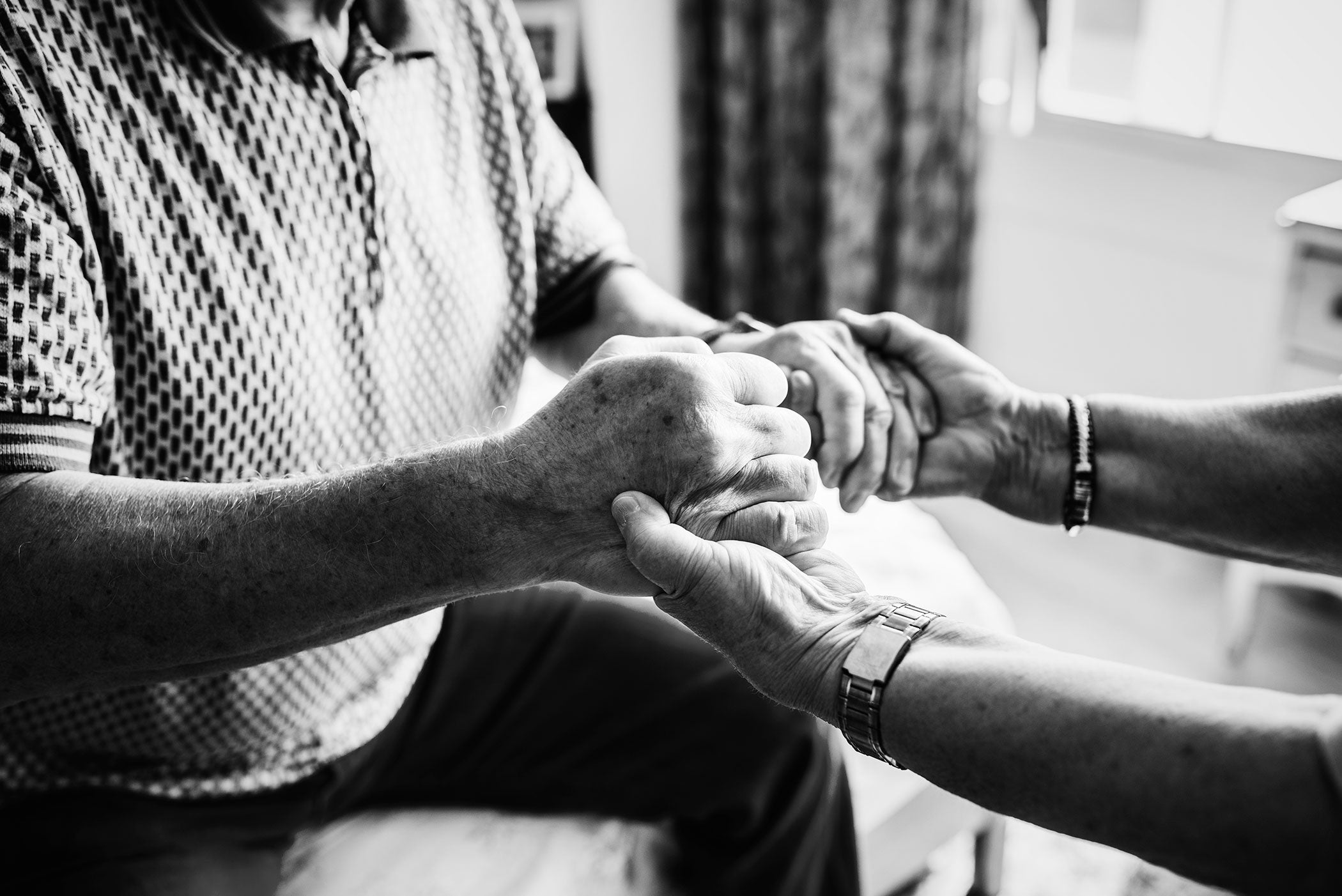 Senior couple holding hands together