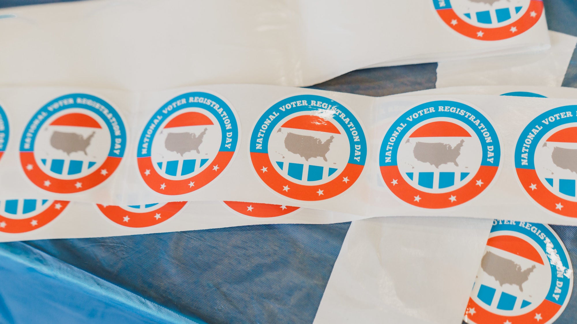 voter registration stickers on a table
