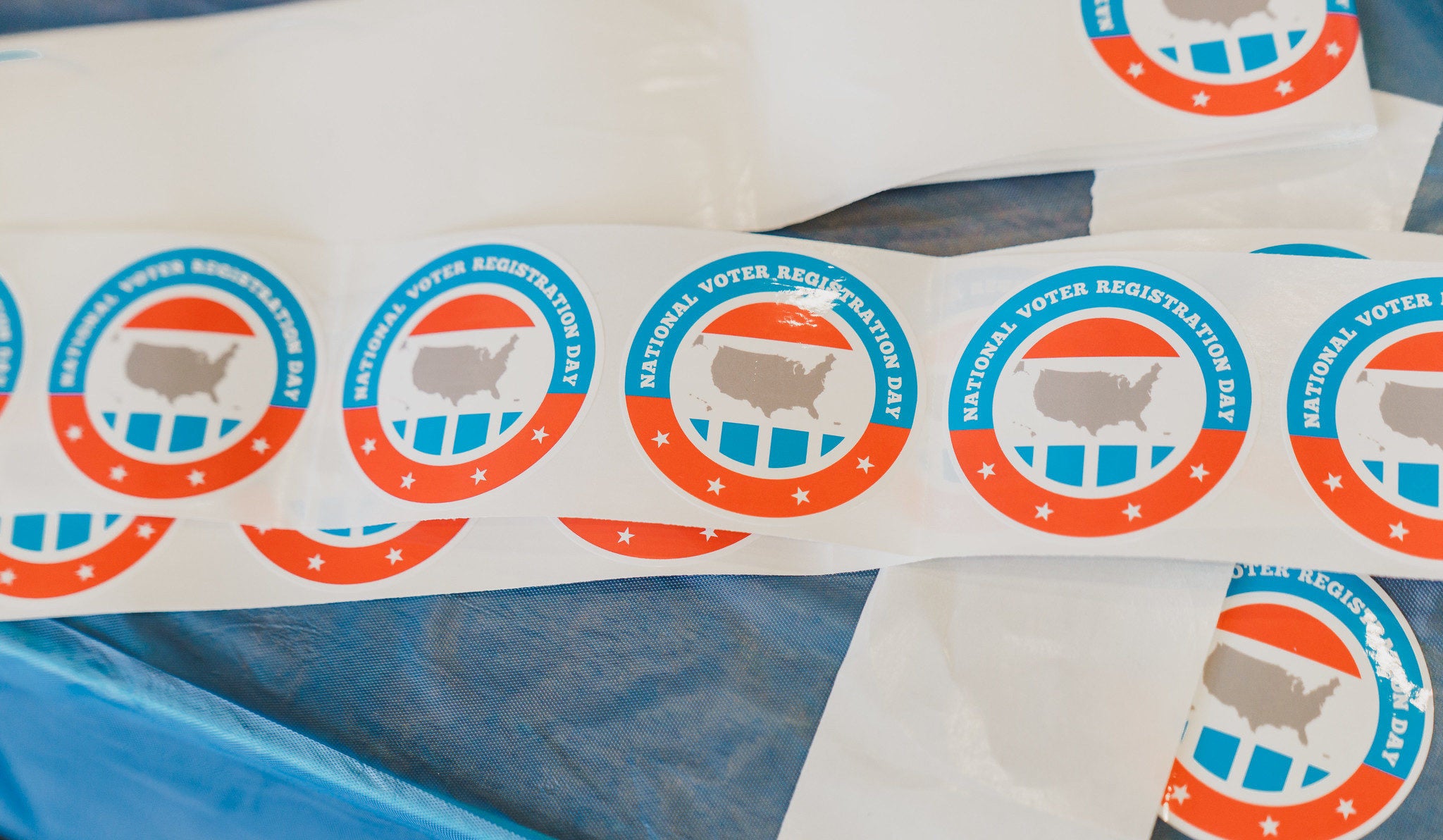 voter registration stickers on a table