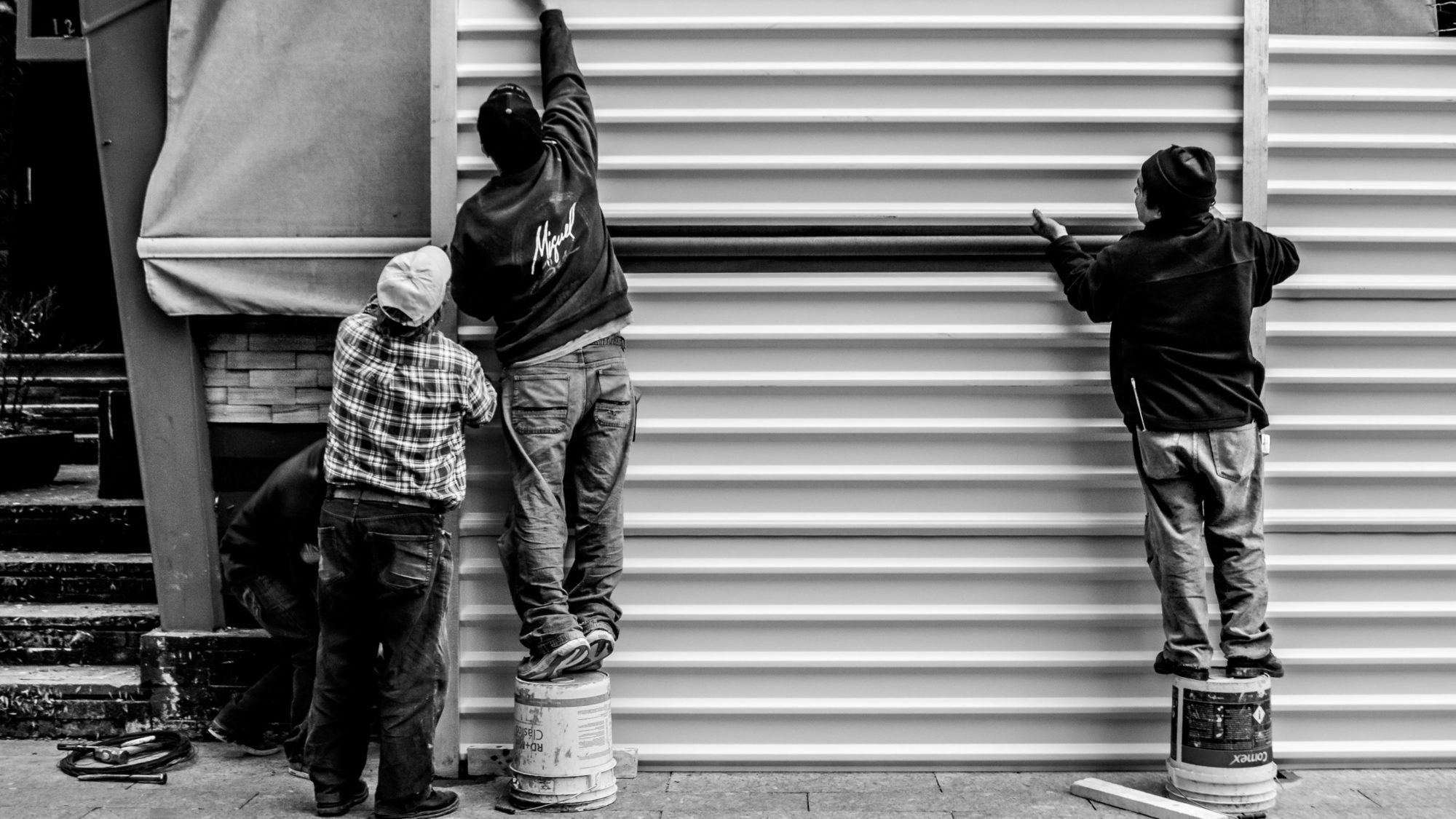 Photo of workers arranging a metal wall