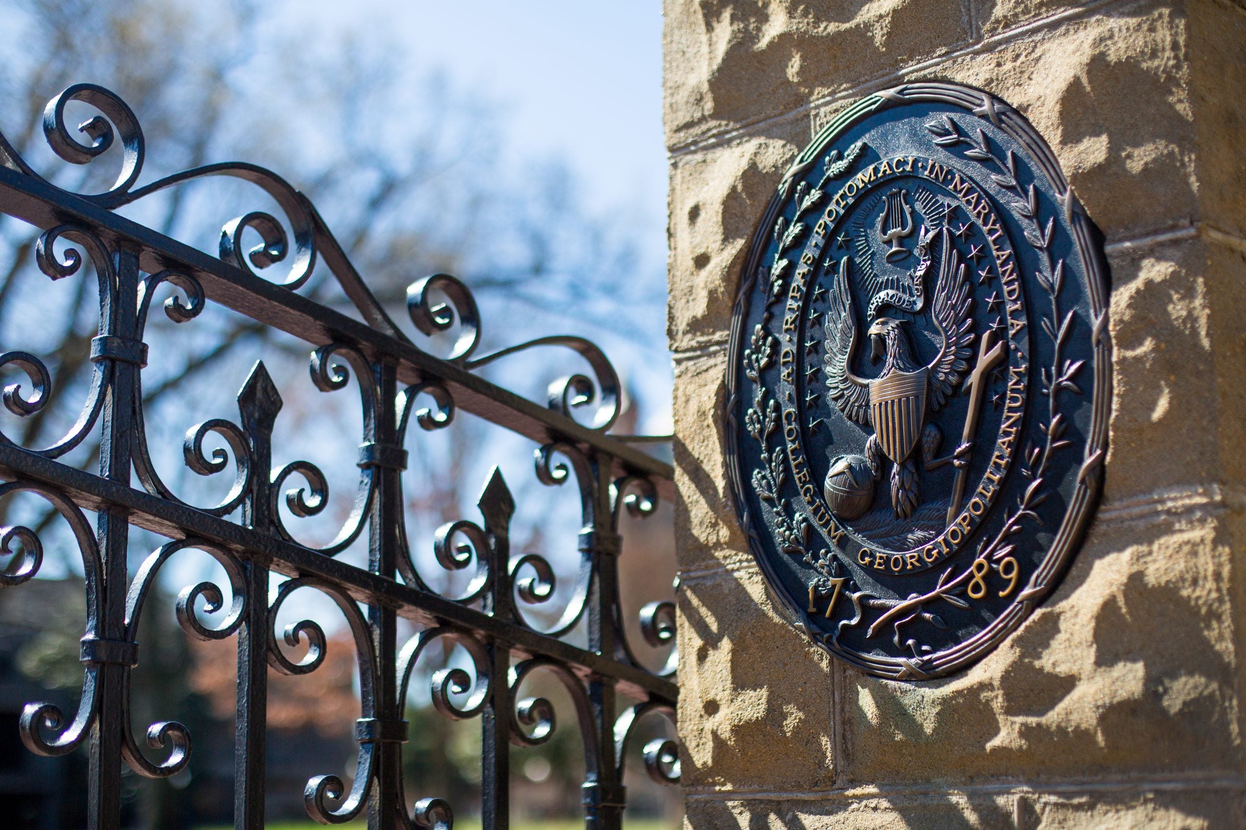 Georgetown front gates with university seal in the foreground