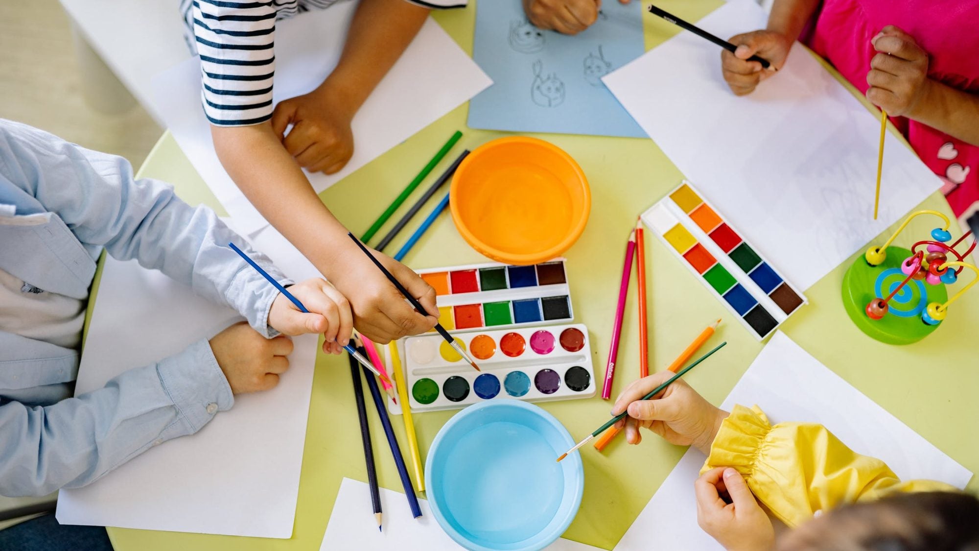 Children playing with a watercolor set