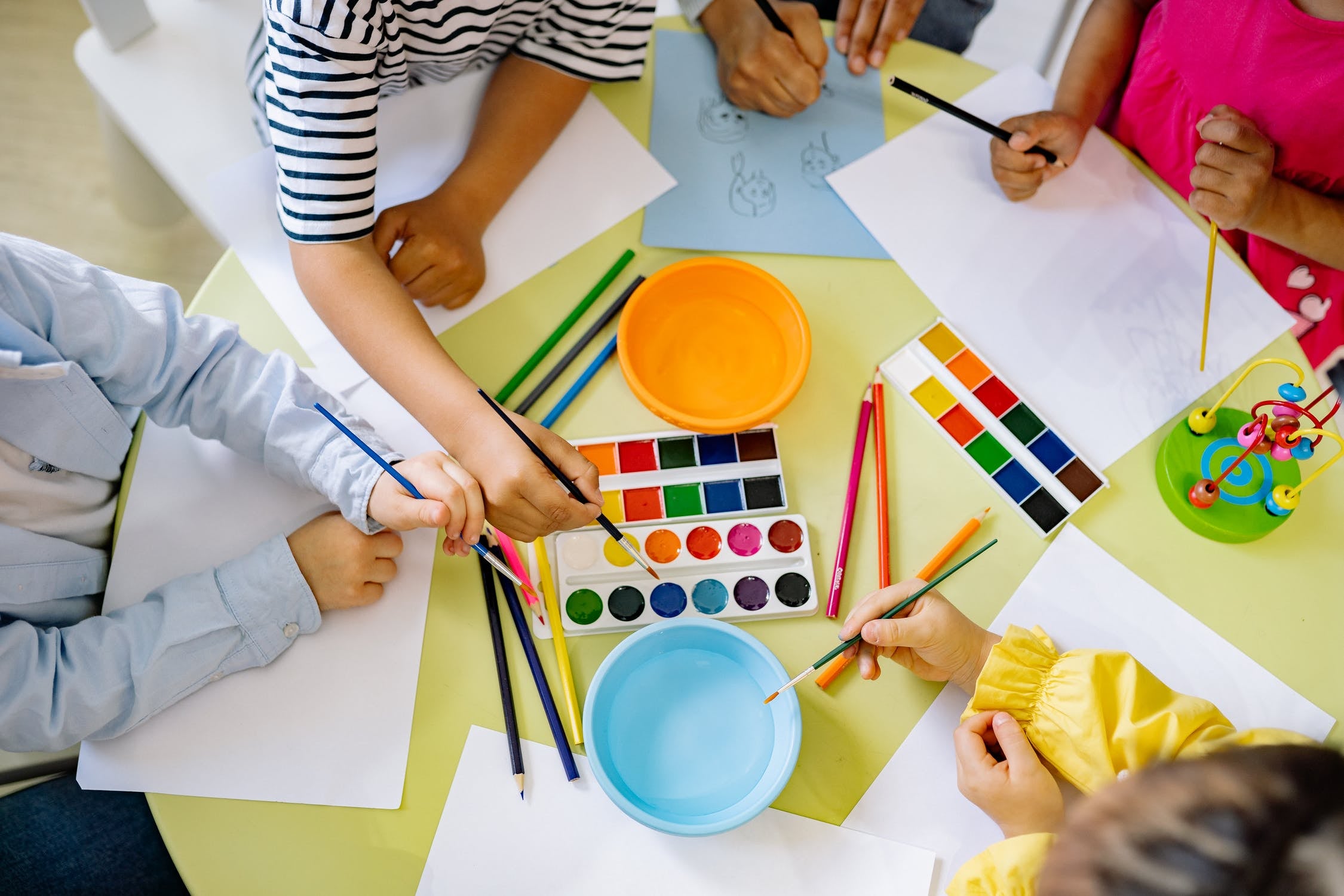 Children playing with a watercolor set