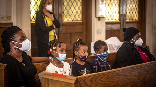 Young children in masks in church