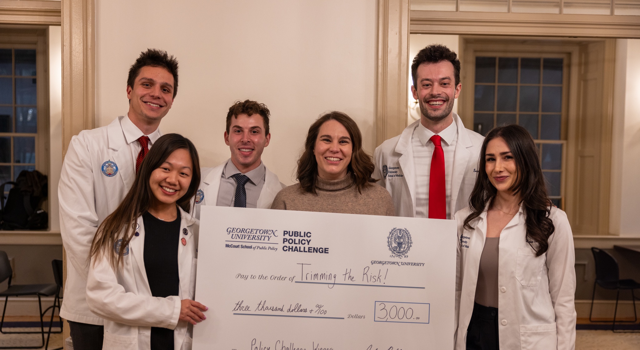 The School of Medicine team pose alongside Jacci Clevenger holding a commemorative check