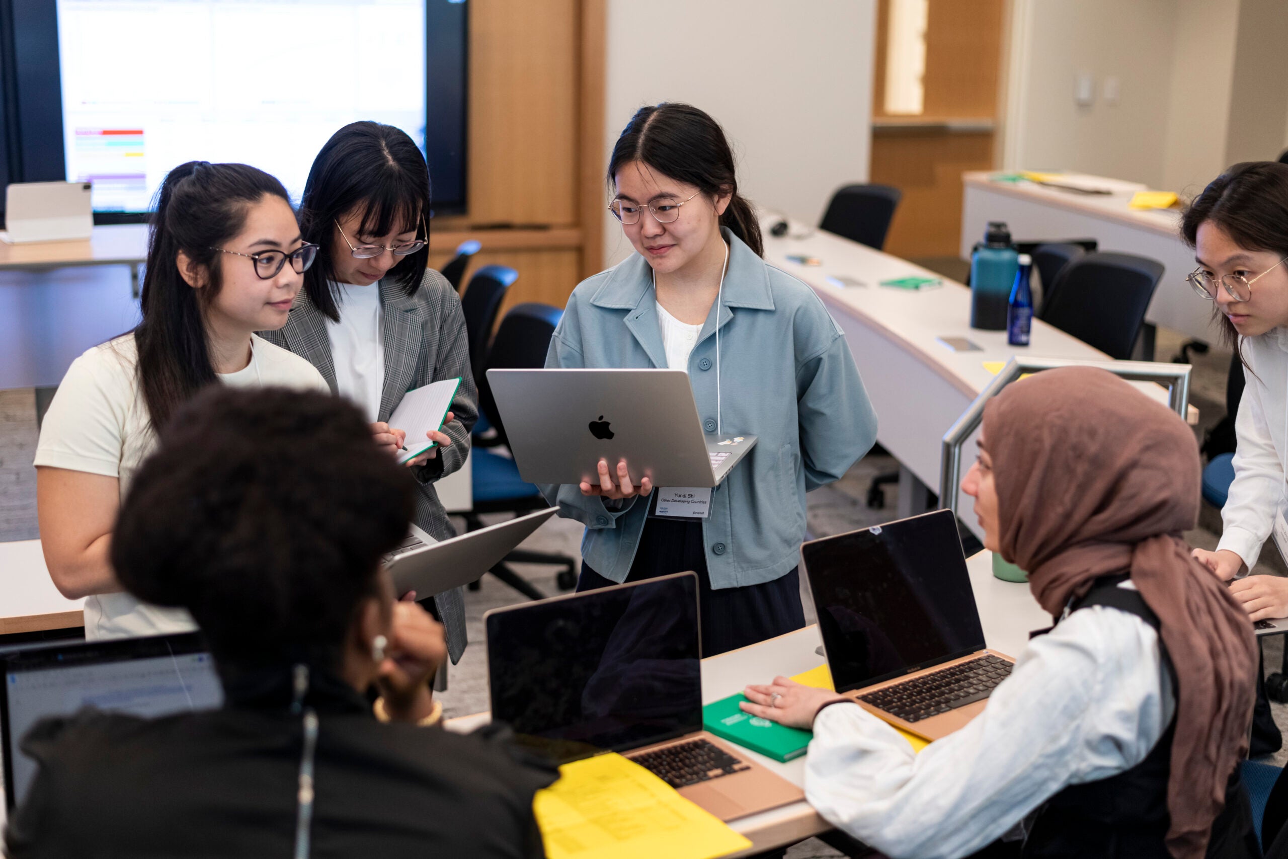 Students working in a group on laptops