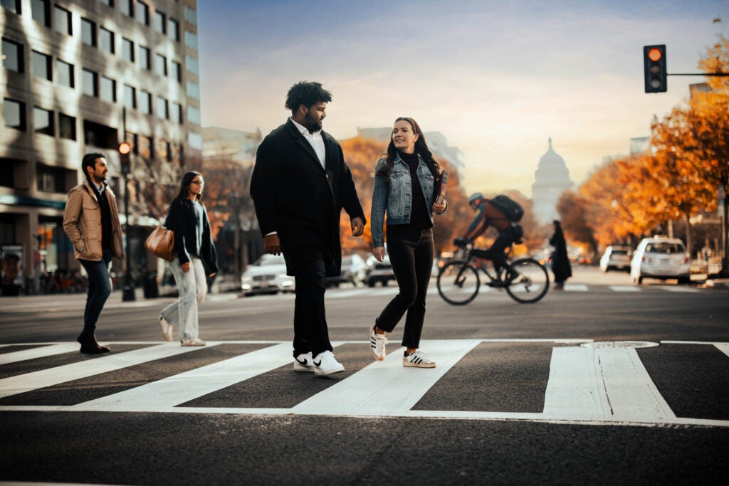 Students crossing street with capitol in background