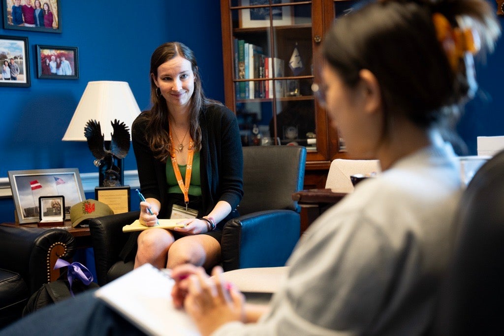 Poling discusses policy solutions in a congressional office, applying her expertise in advocacy to support impactful decision-making.