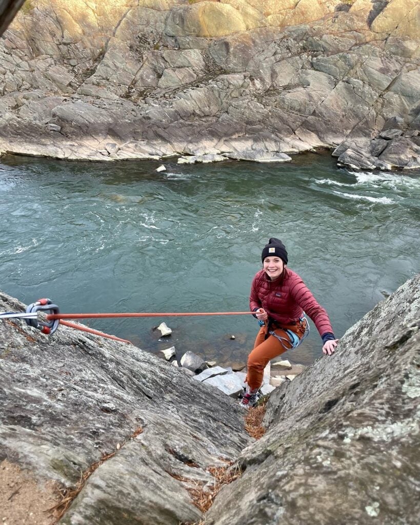 Emma Wyma (MPP'23) rock climbing along the Potomac River.