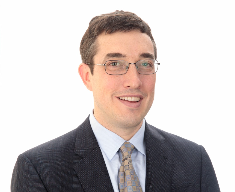 Chris Warshaw stands for a professional headshot