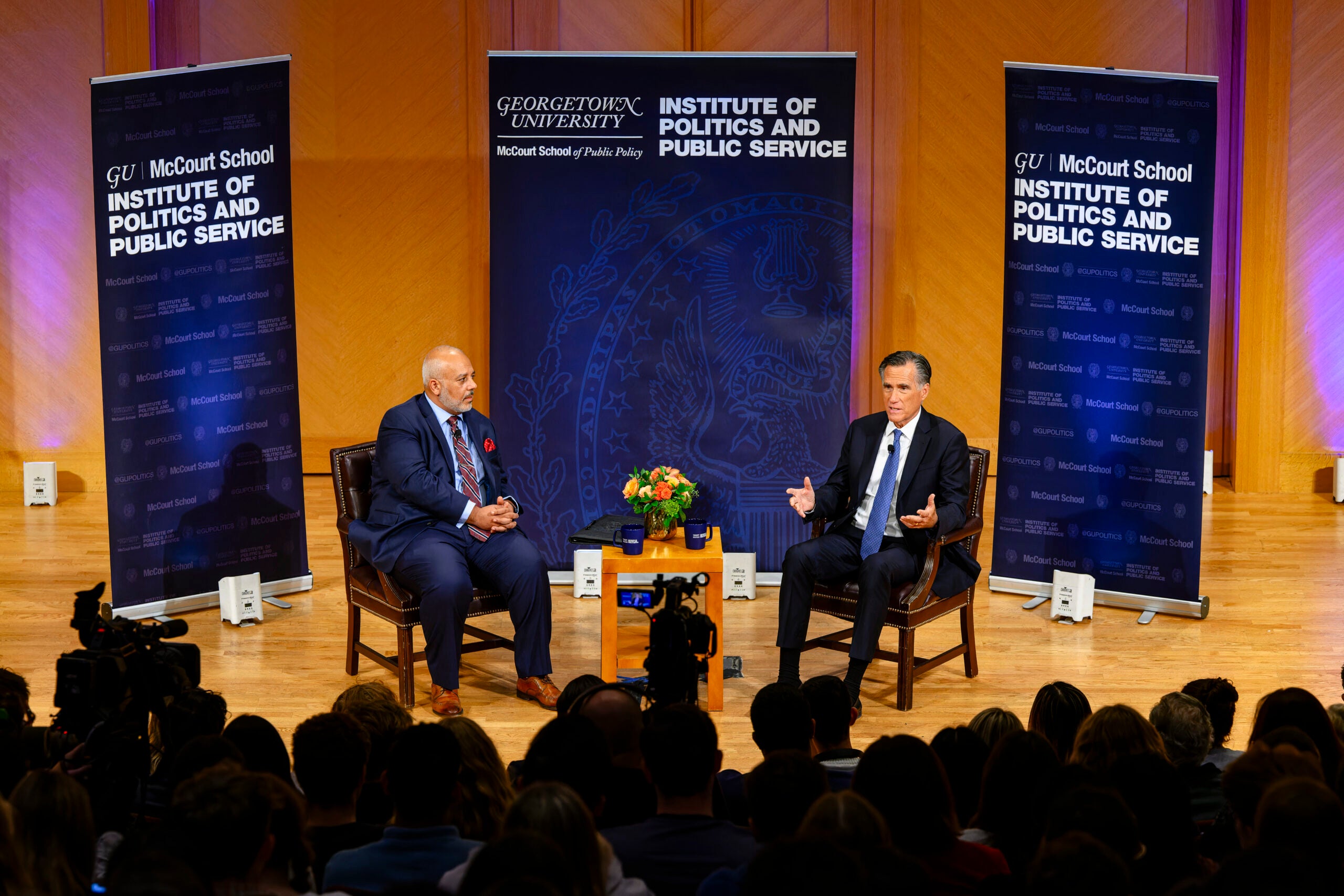 Sen. Mitt Romney (R-UT) speaks with executive director Mo Elleithee.