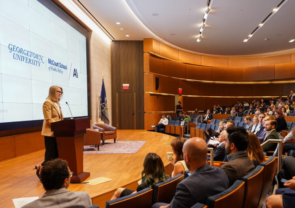 Dean Carole Roaz Gresenz gives opening remarks at the symposium