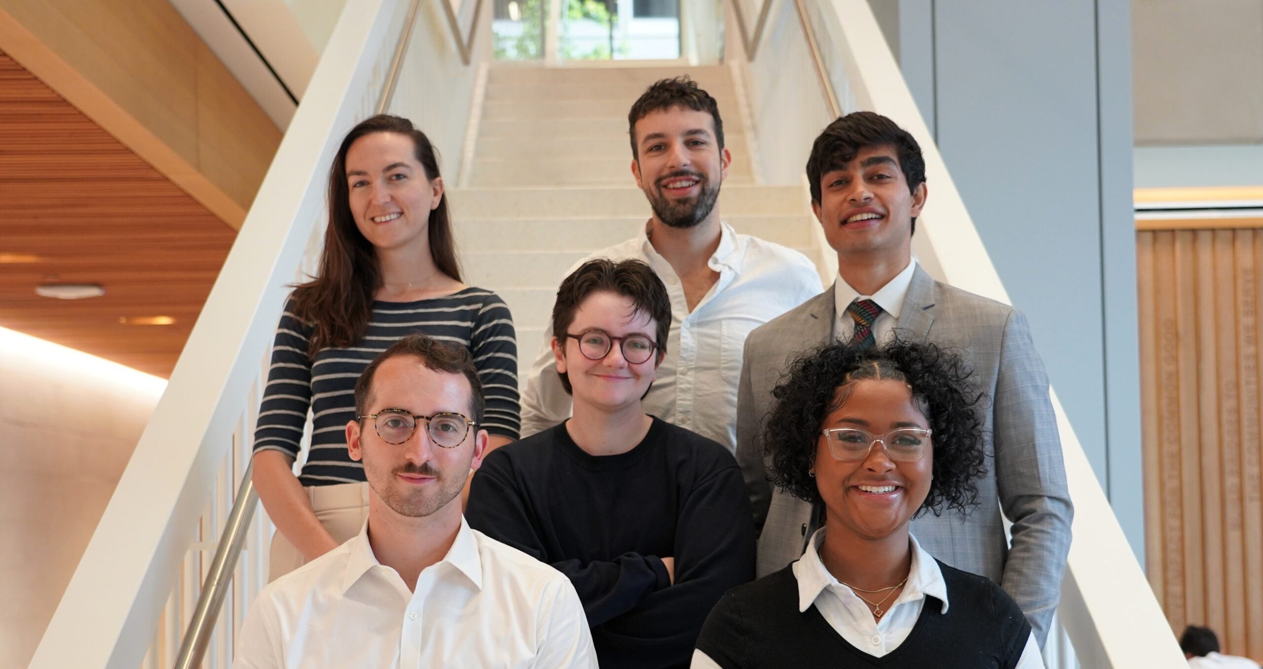 The 2025 TPP Scholars stand as a group on the steps of McCourt