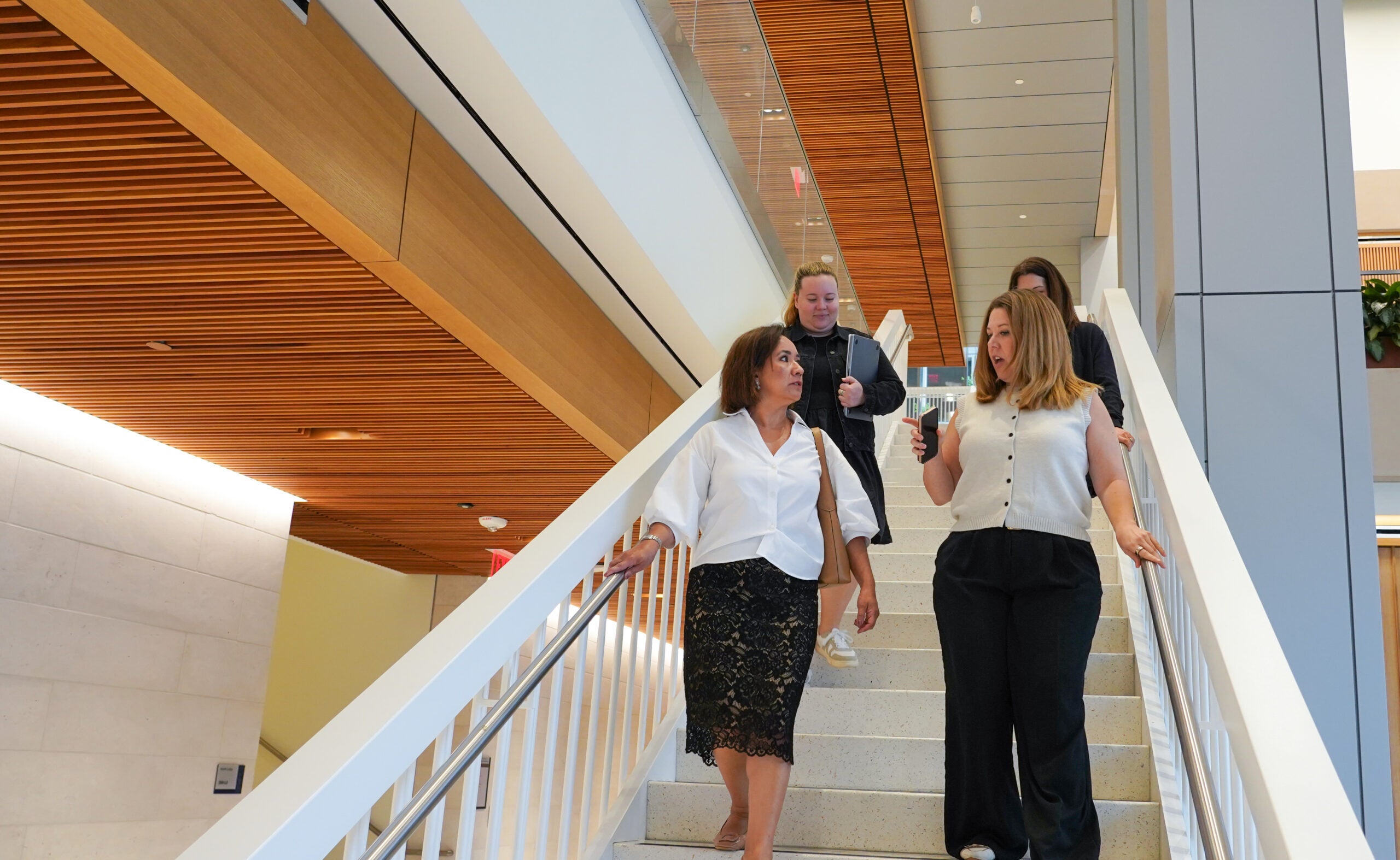 EMPL students pictured on the stairs at the McCourt school