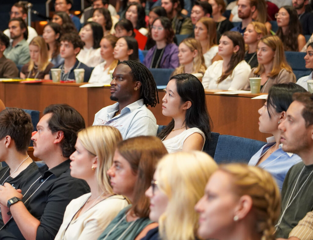Students listening to lecture in large auditorium