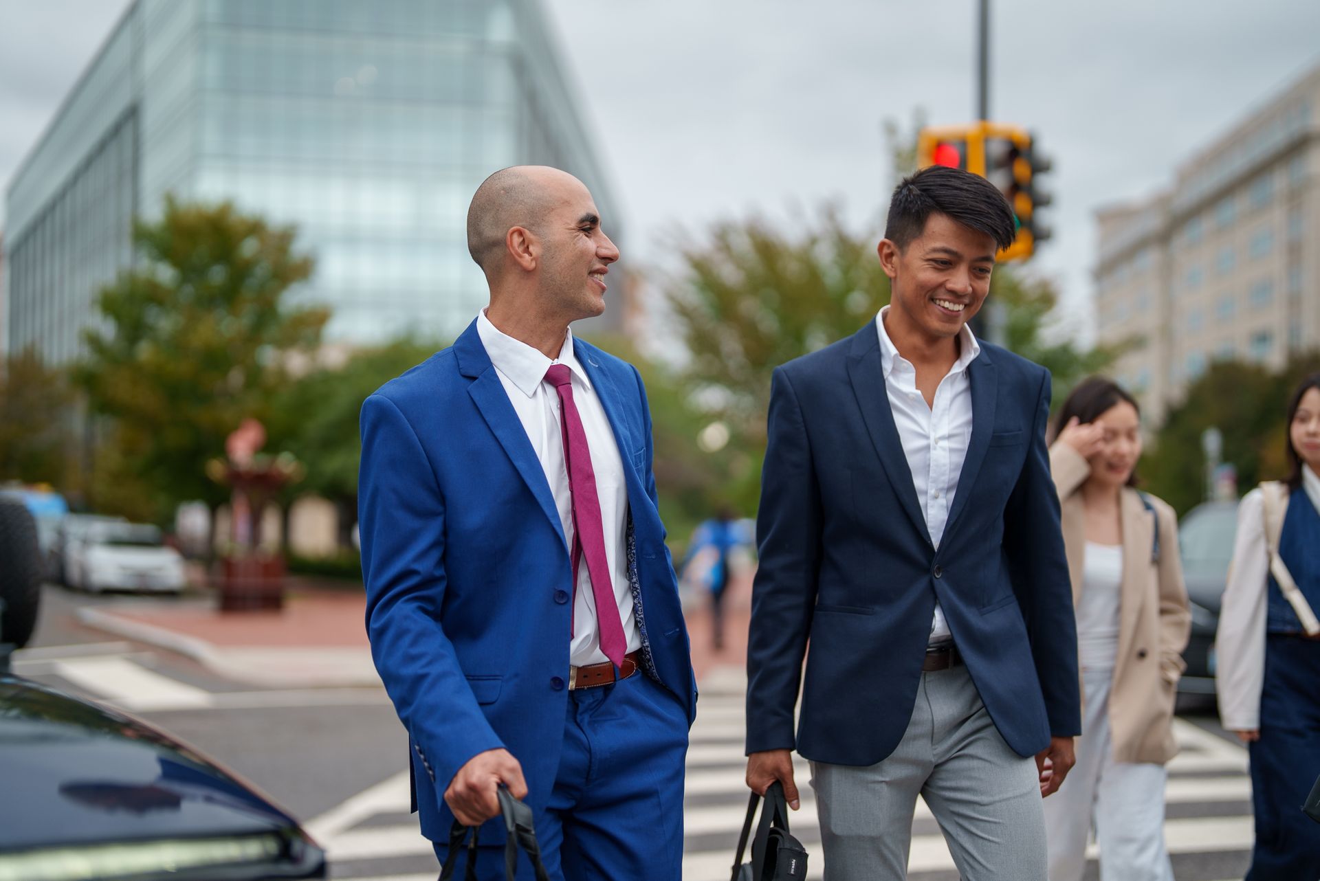 Two students walking together outside and talking.