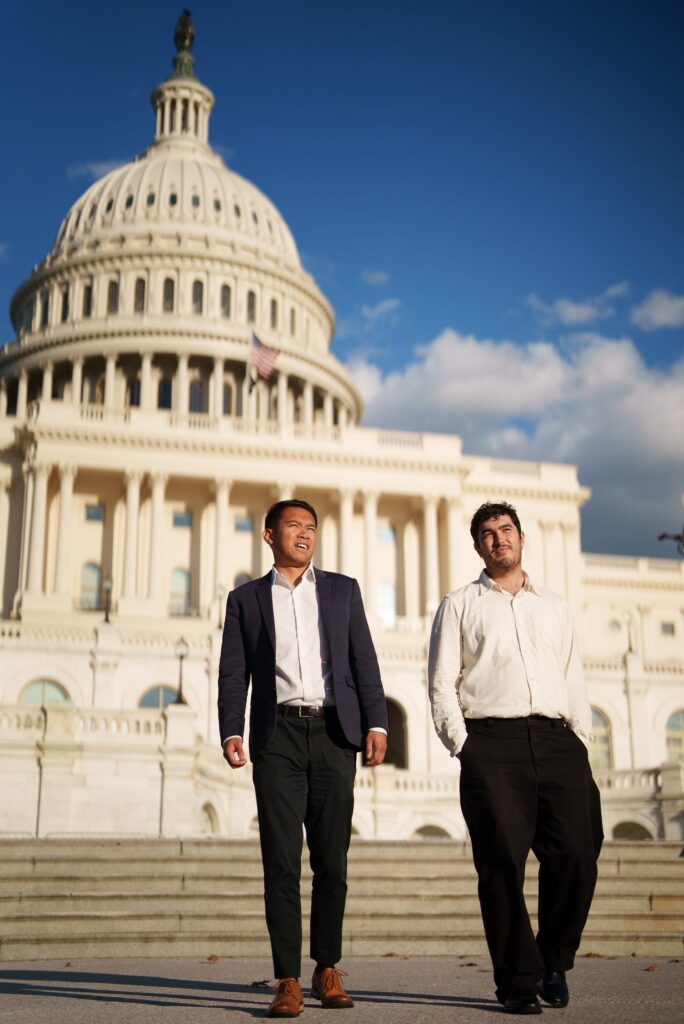 Two students walking together in front of the US Capitol building.
