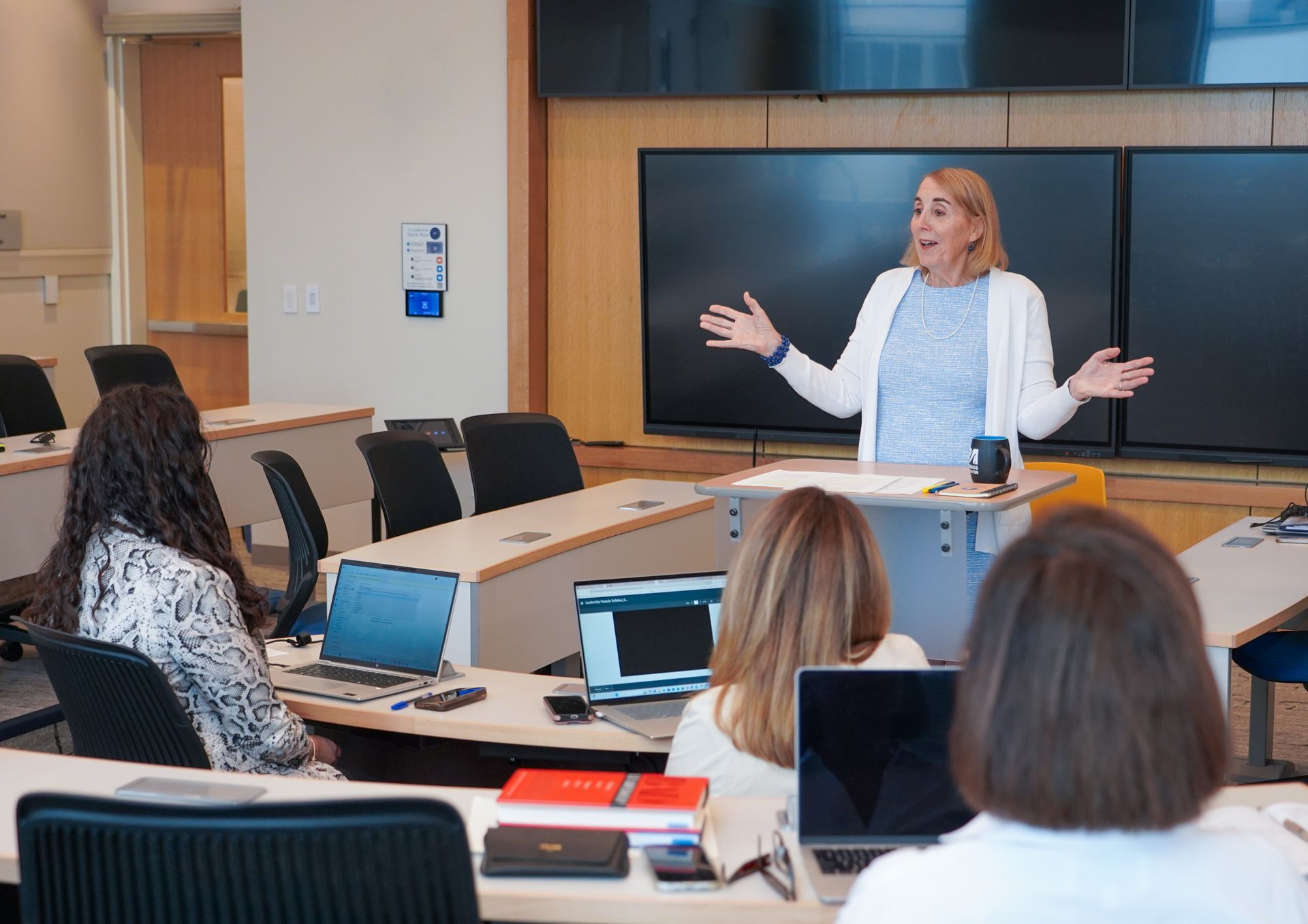 An instructor is giving a lecture in class.