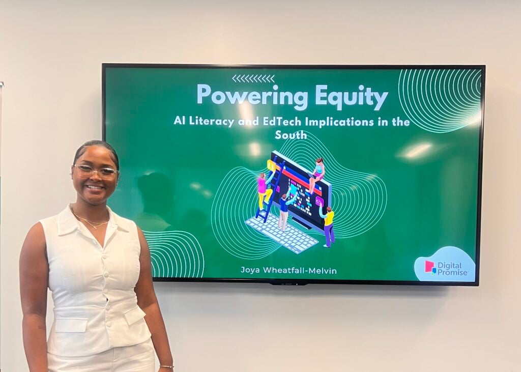 Joya Wheatfall-Melvin (MS-DSPP'26) stands in front of screen showing her project "AI Literacy and EdTech Implications in the South"