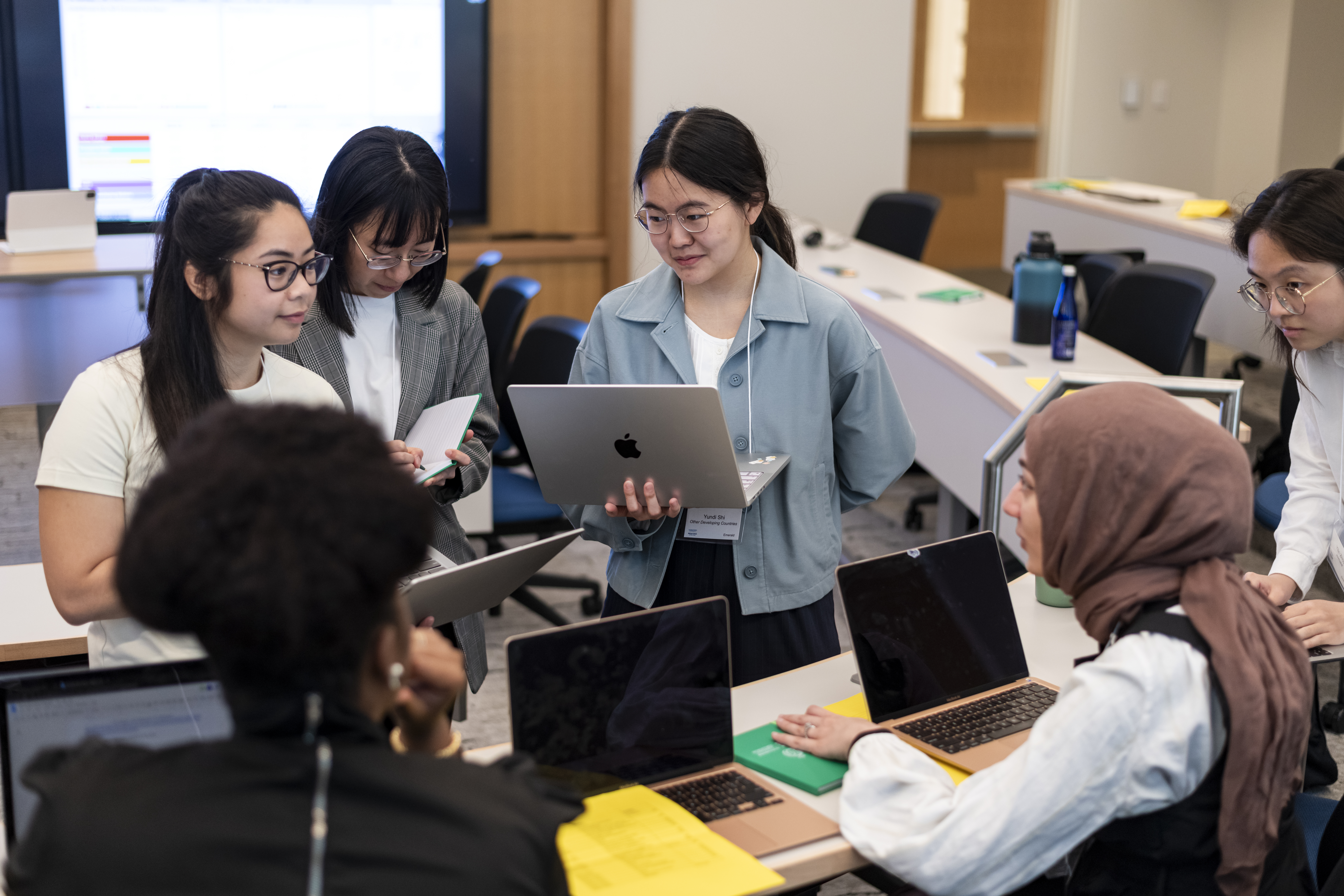 A group of students working with their laptops out