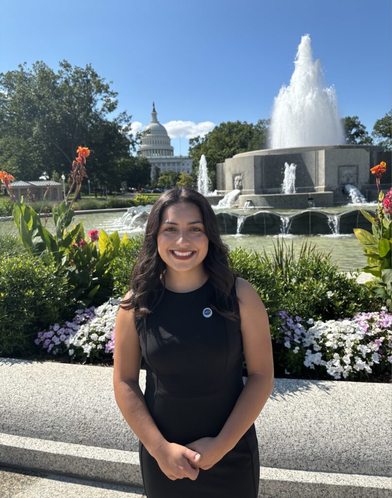 Ciannah Correa professional headshot, taken outside in front of a fountain