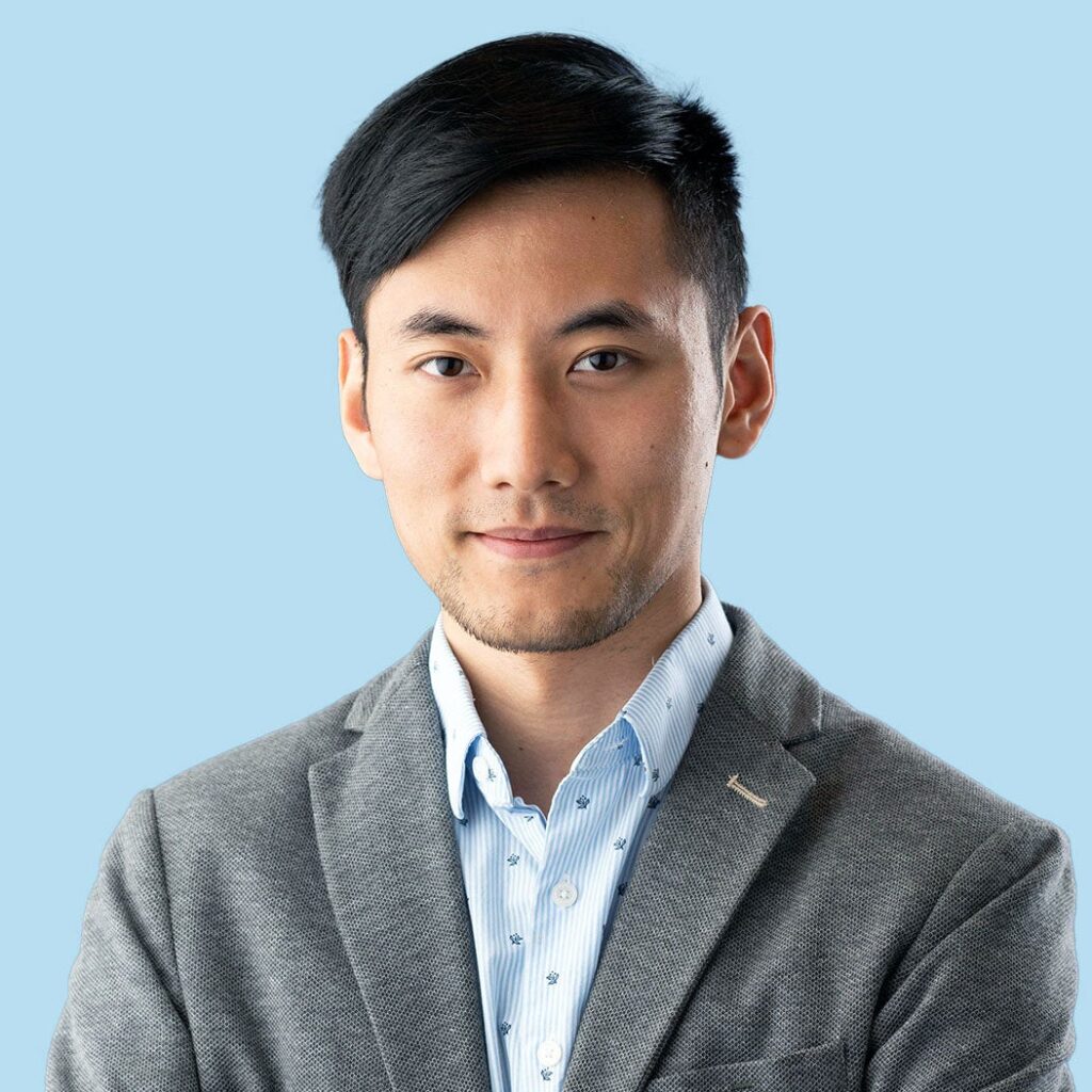 Fan Zhang professional headshot against a light blue background