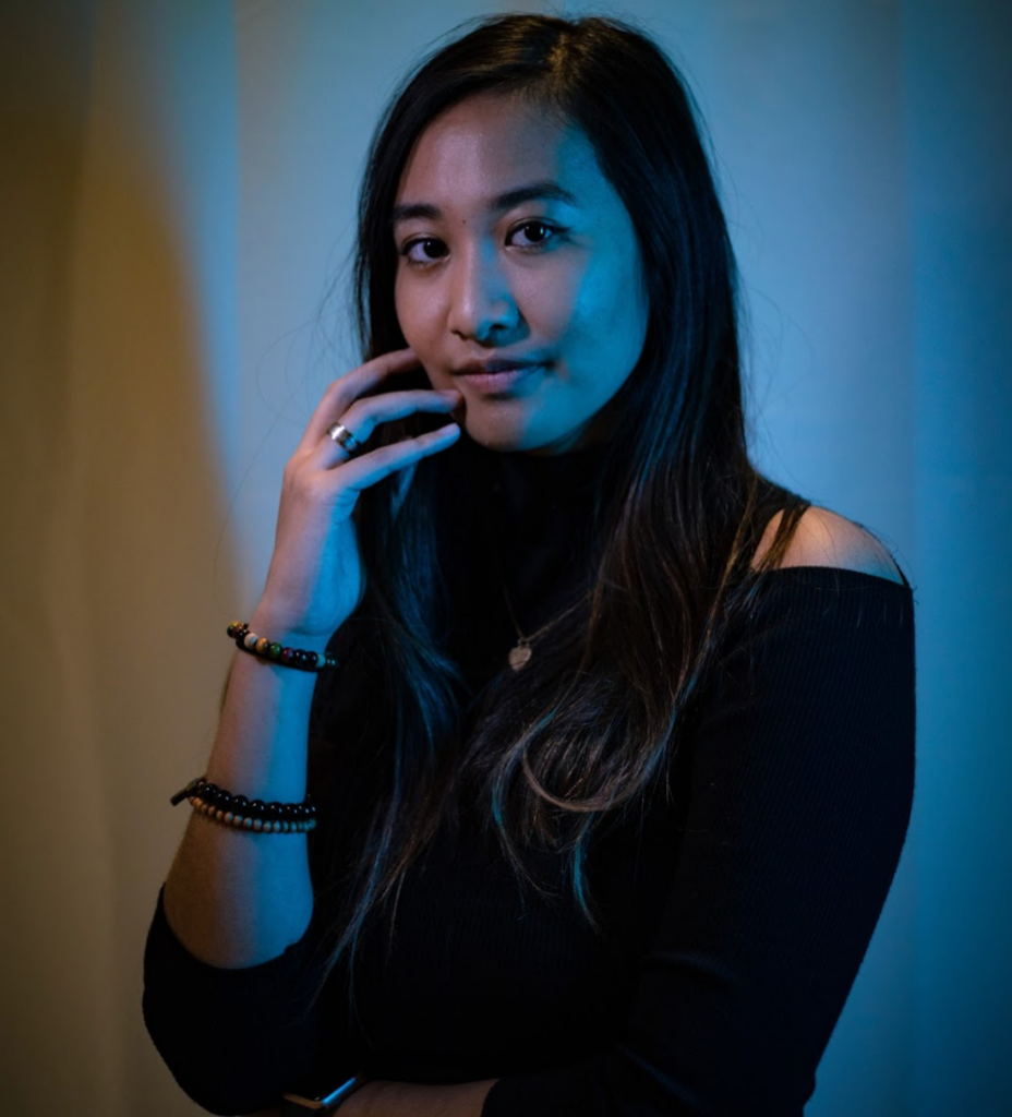 Kim Estoque professional headshot in blue lighting