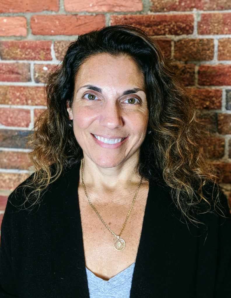 Tricia Waller against a brick wall