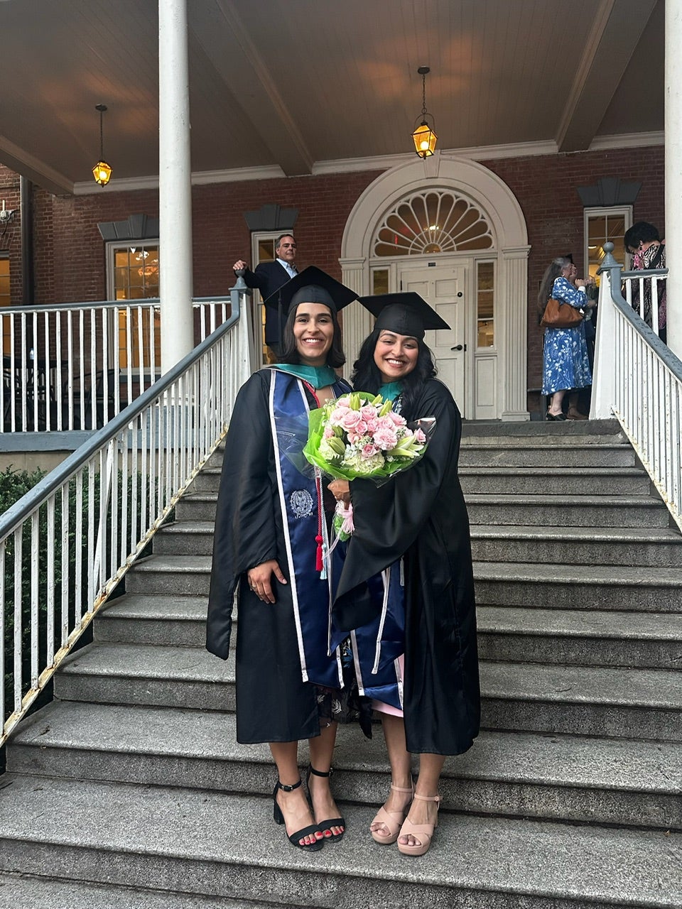 Walkin stands on steps with friend after McCourt graduation ceremony