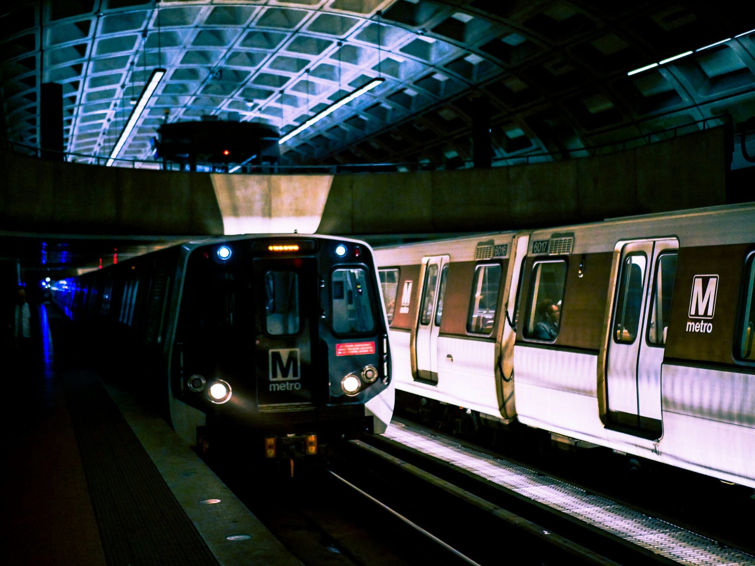 A WMATA train pulling into station, darkly lit