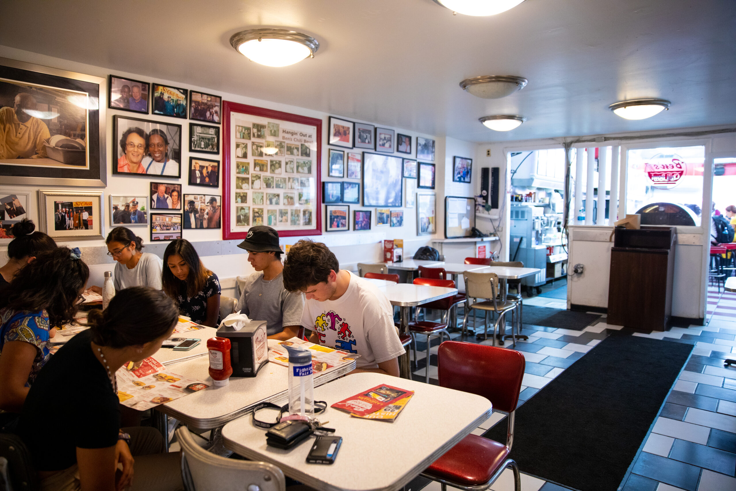 Group of student sitting at restaurant table with well-decorated walls