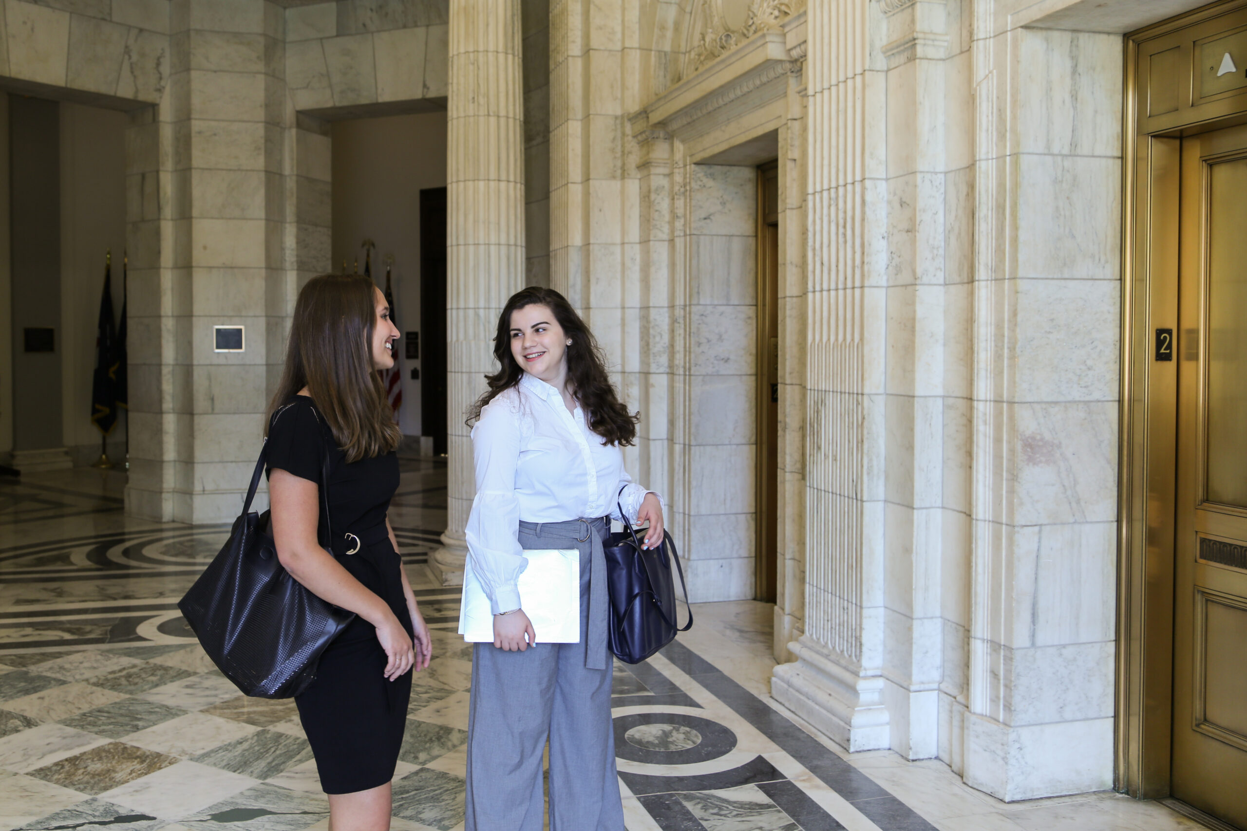 Two women waiting for elevator at Capitol building