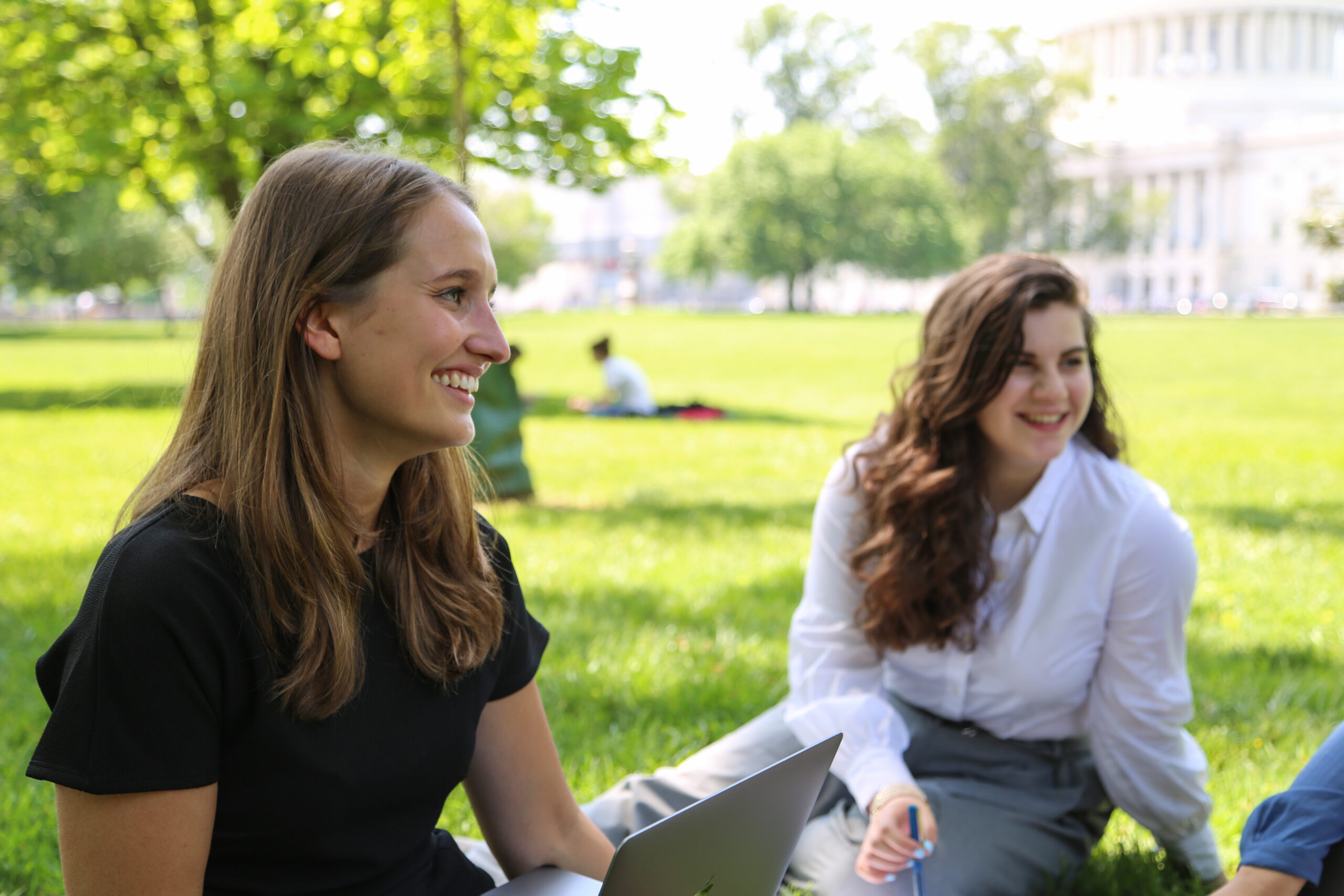 Two women sitting on Capitol Lawn