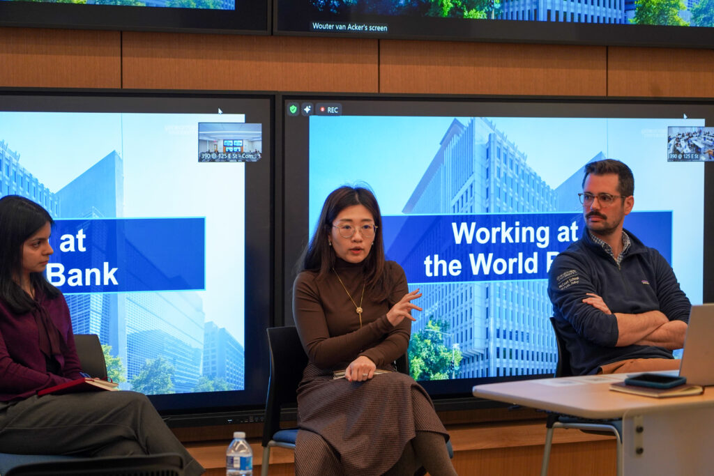 Three people sitting in front of TVs displaying "Working at the World Bank"