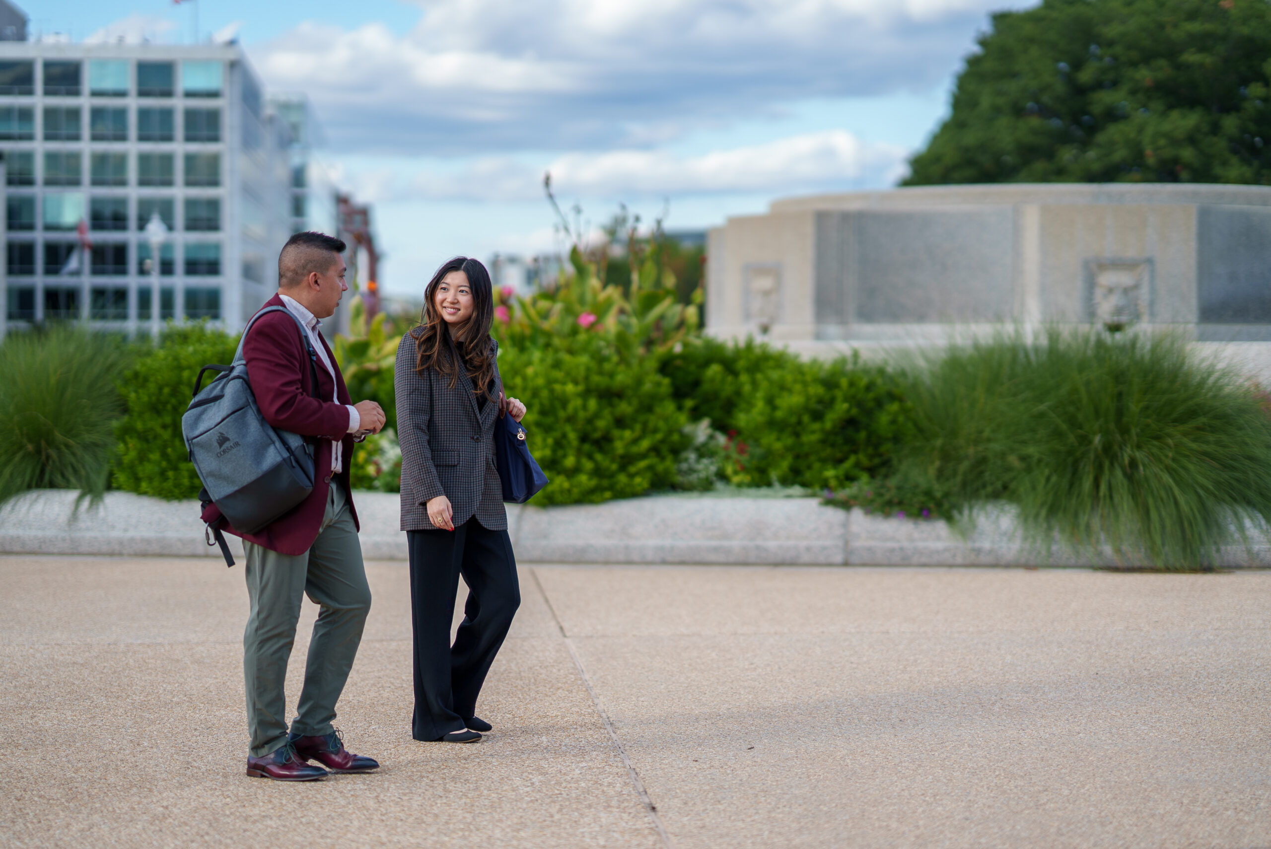 Two people walking across the US Senate Lawn