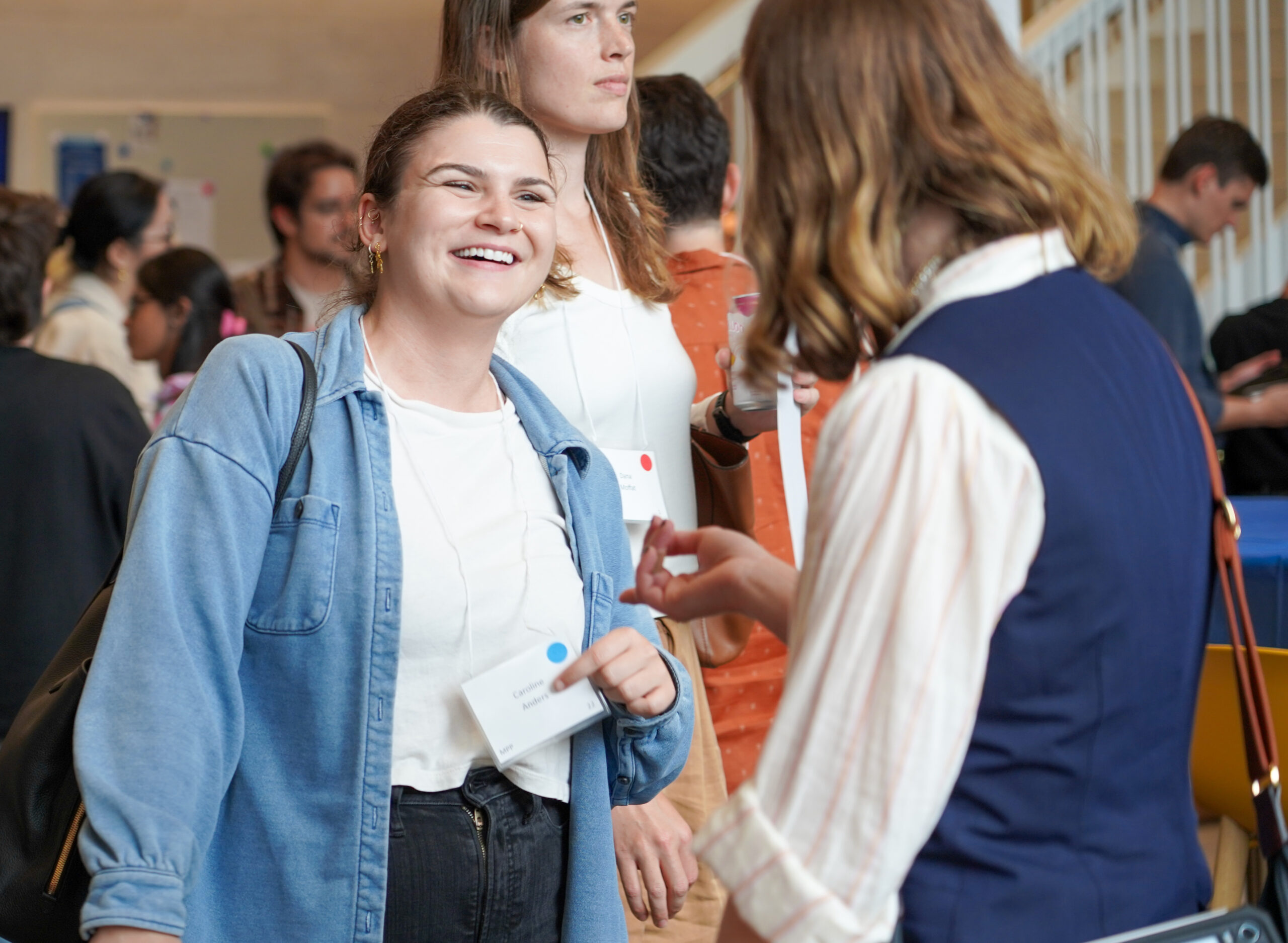 Two people engage in conversation in crowded room