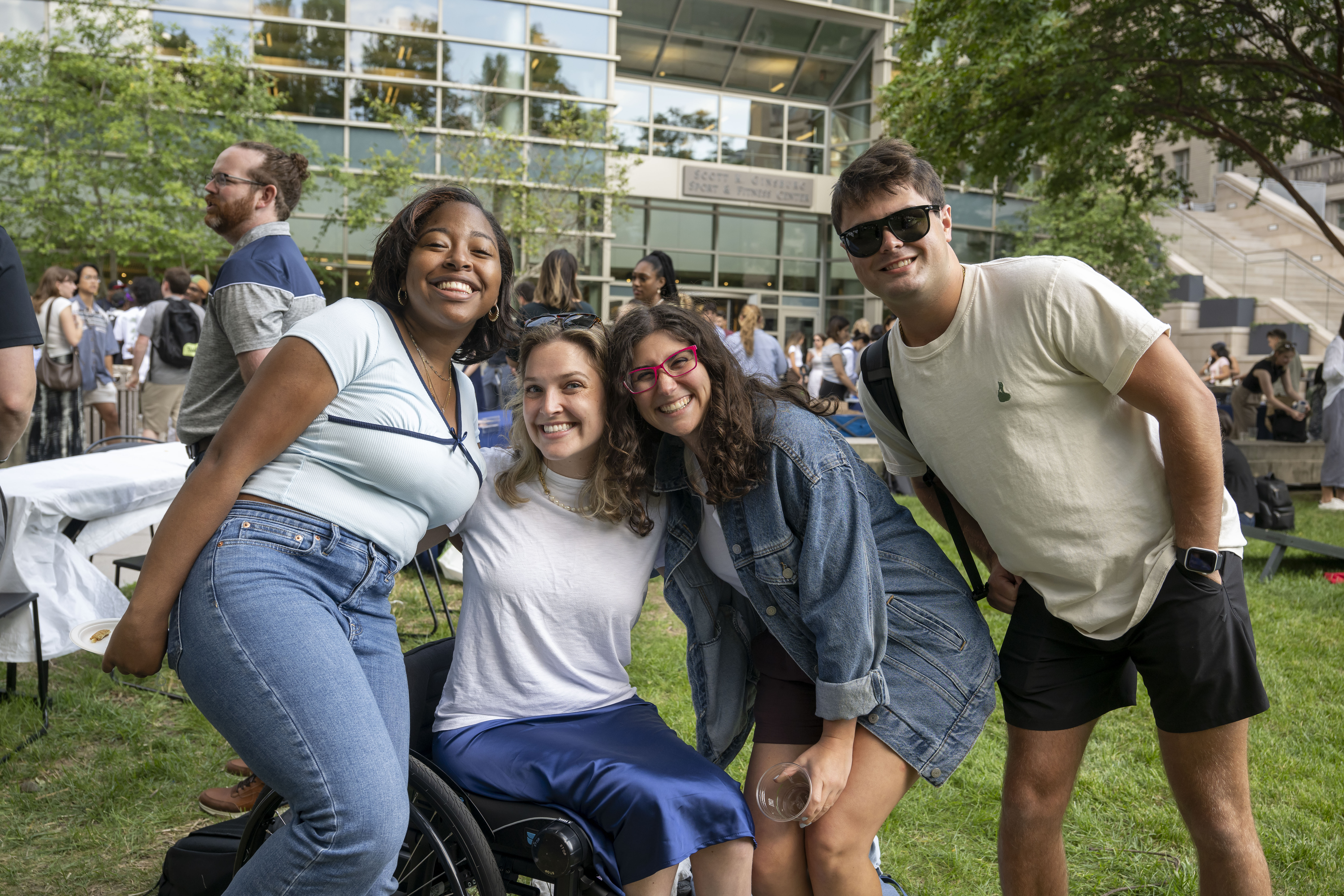 Four students posing side-by-side on Capitol Campus lawn