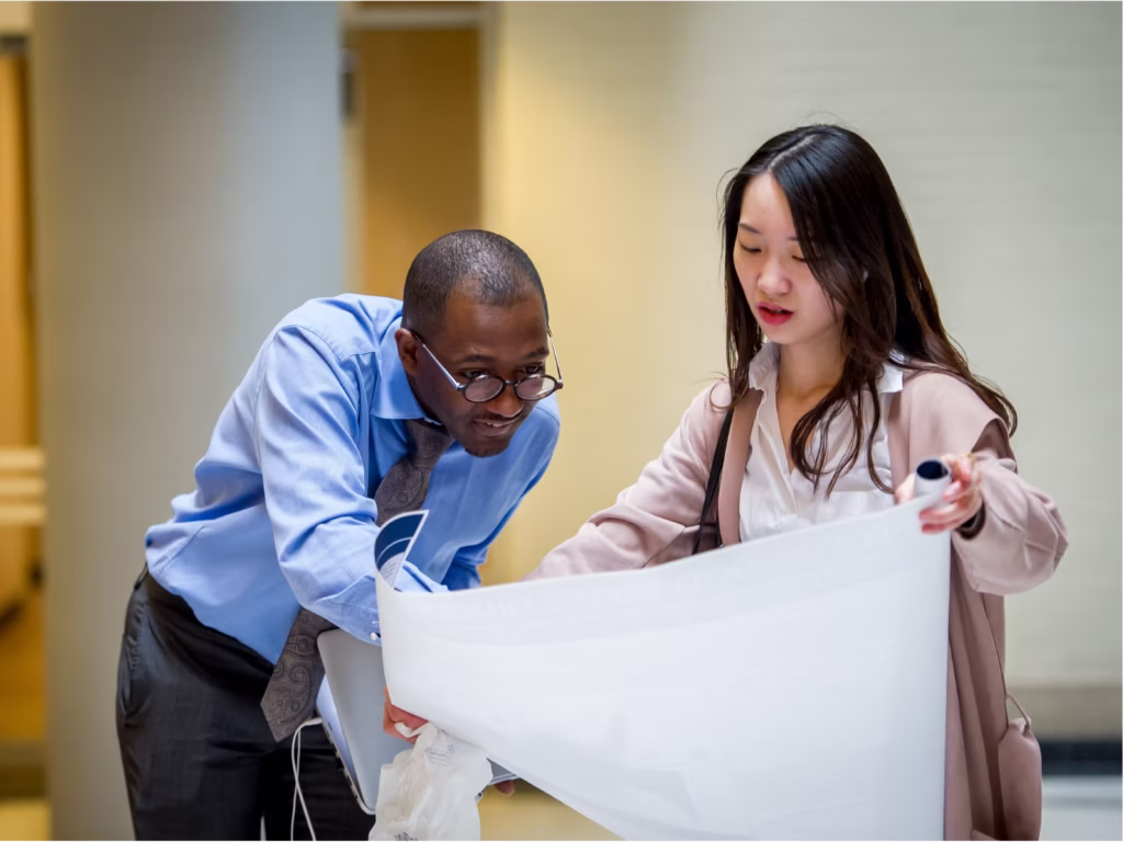 Two MS-DSPP students looking at a presentation.