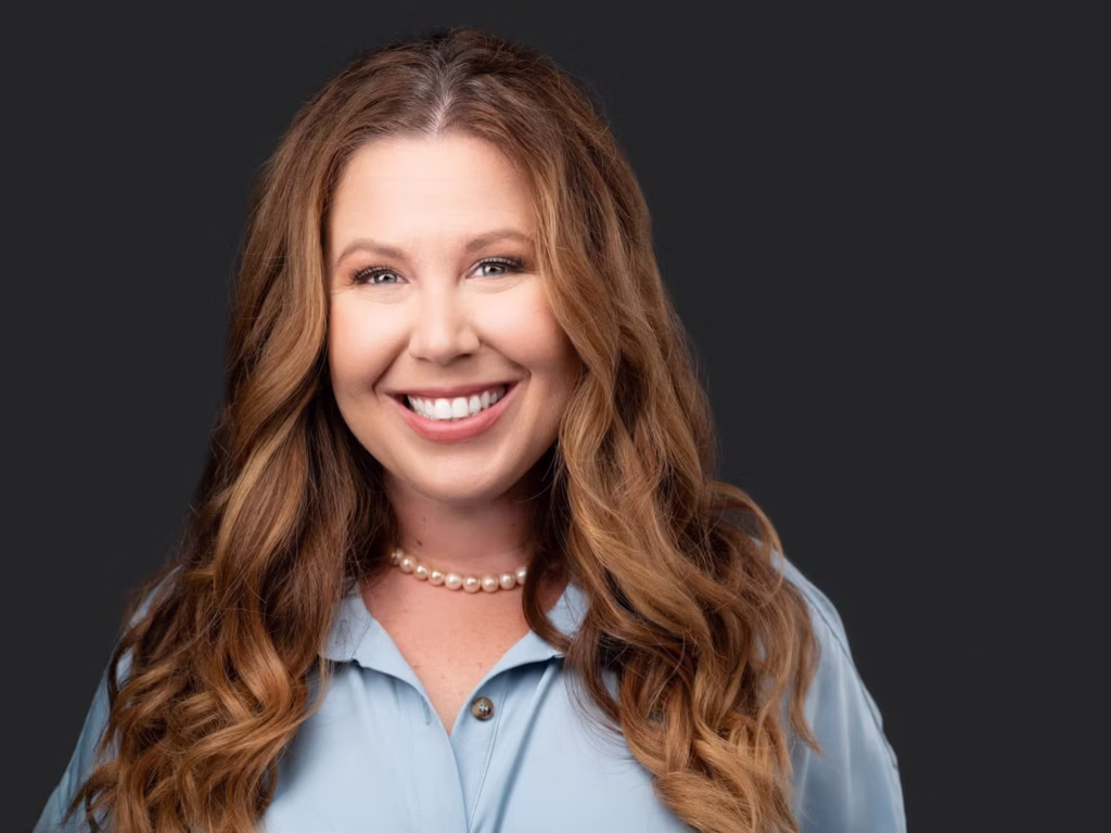 Jennifer Ross wearing a light blue button down shirt.