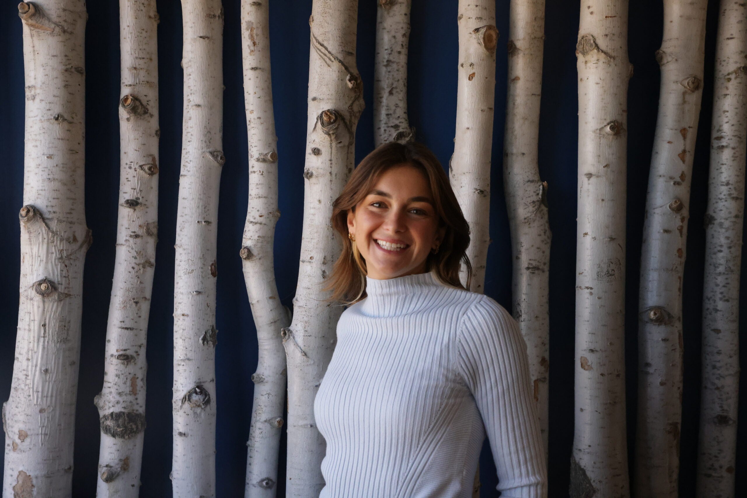 Talia Stringfellow professional headshot in front of faux birth tree background
