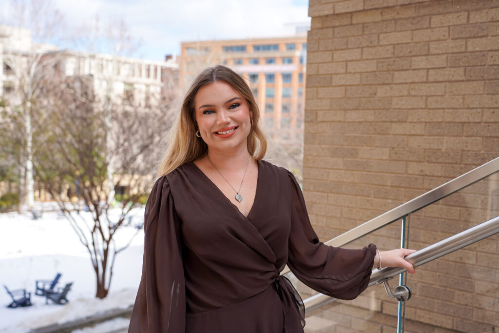Abbey Basa on Georgetown's Capitol Campus, smiling toward camera
