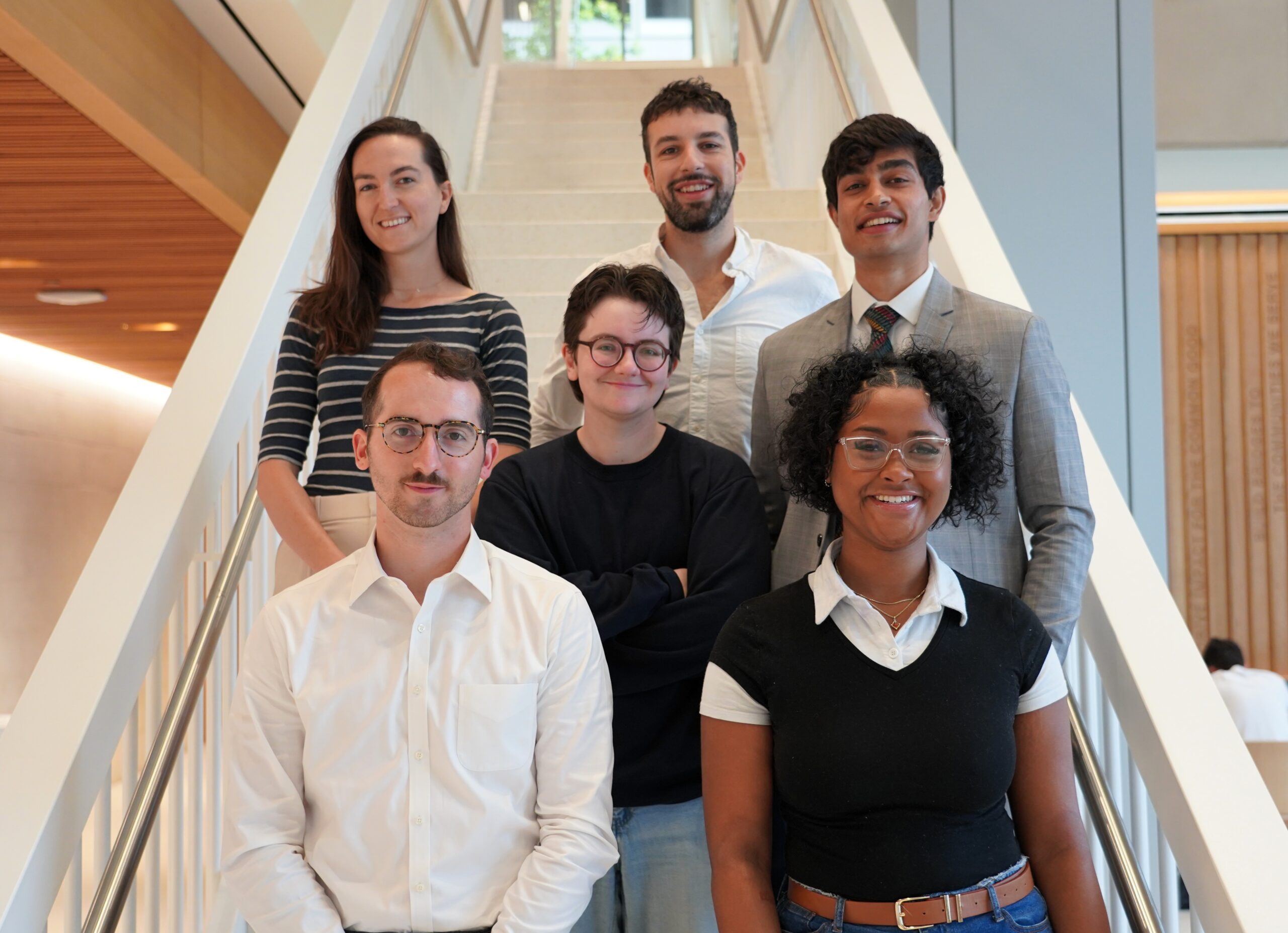 The 2025 TPP Scholars stand as a group on the steps of McCourt