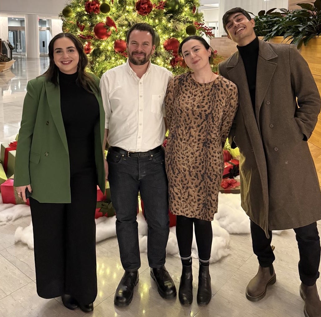 Four people standing side-by-side